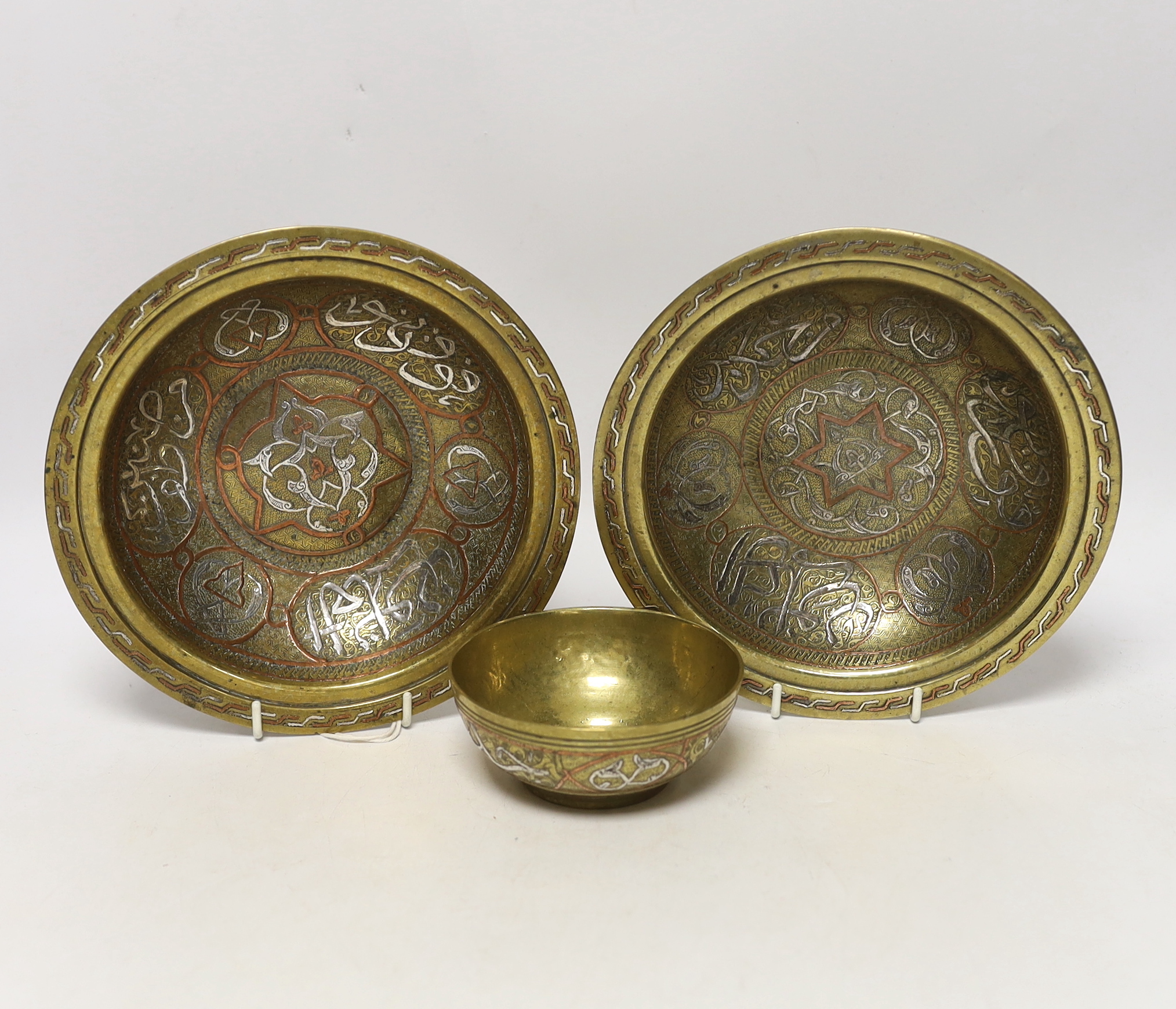 A pair and another inlaid brass dishes, Cairo ware, largest 19cm